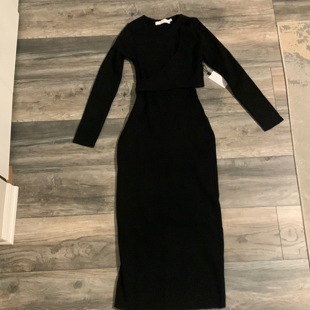 Alora black sweater dress with small cutouts on left side.